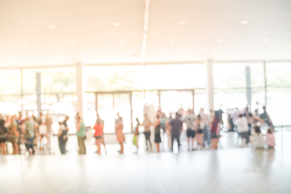 photograph of diverse crowd waiting in line