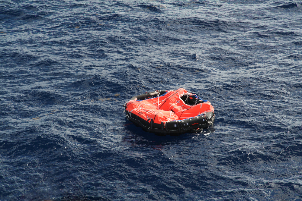 photograph of small liferaft at sea