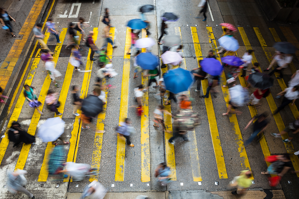 photograph of blurred pedestrians crossing intersection