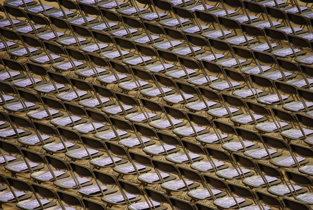 photograph of graudation programs on rows of empty chairs