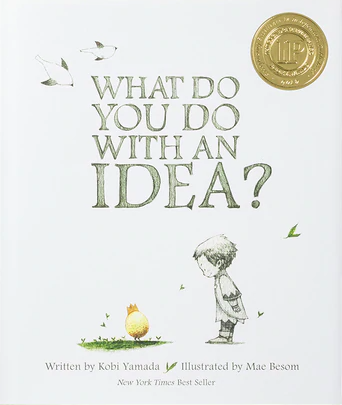 Illustrated children's book cover for What Do You Do with an Idea? of a mostly white background, with a small boy looking down at a golden orb on the grass.