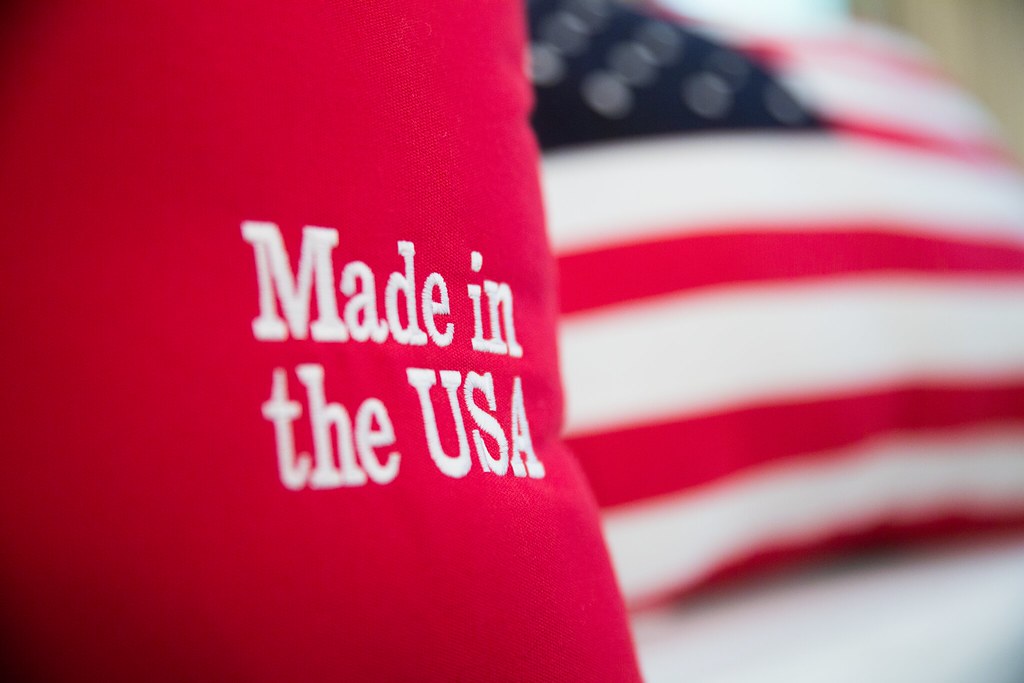 photograph of "Made in the USA" embroidered pillow will US flag pillow in background