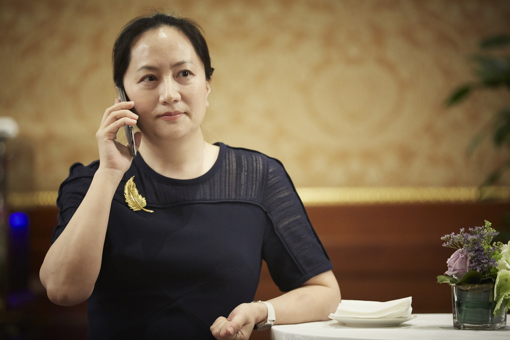 photograph of Meng Wanzhou on a moblie phone at business function