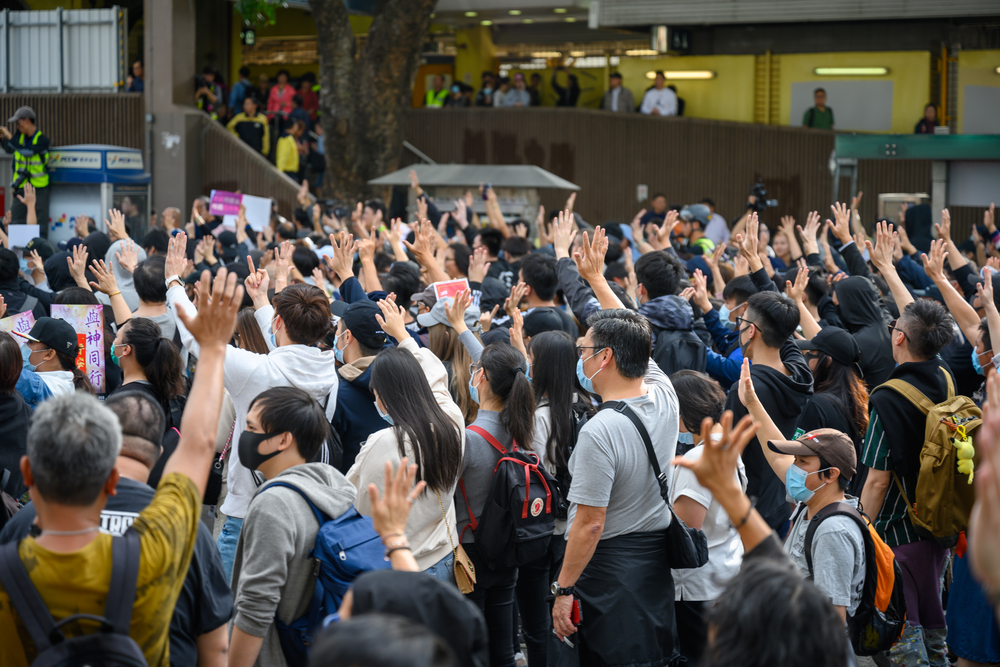 photograph of peaceful protest in Sheung Shui district arms raised