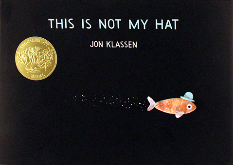 Cover image for This Is Not My Hat featuring an illustration of an orange fish with a tiny blue hat swimming through the dark ocean depths