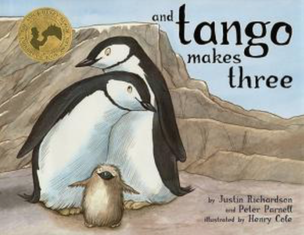 Illustrated book cover for And Tango Makes Three featuring two male penguins cuddling with a baby penguin in a rocky landscape.