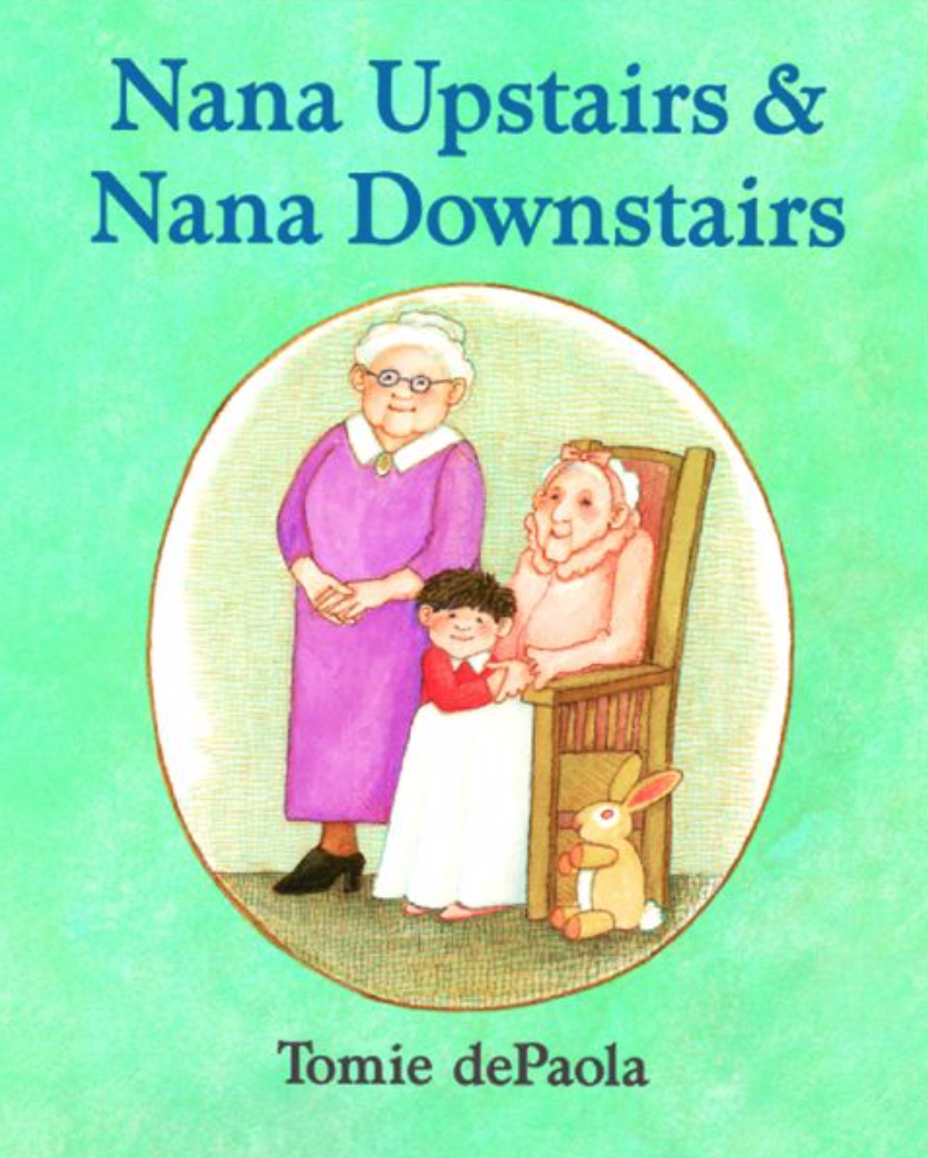 Cover image of the book Nana Upstairs and Nana Downstairs with an illustration of two older ladies with a young child standing between them. One of the ladies wears a pink dress and stands while the other lady wears a sleeping jacket and sits in a wooden chair. A small bunny sits at the feet of the seated woman.