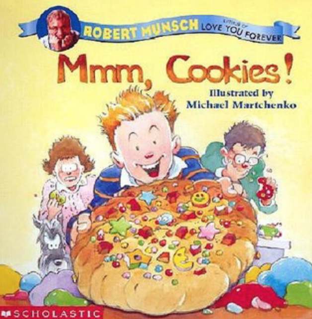 Illustrated book cover for Mmm, Cookies! featuring a boy holding out a heavily decorated clay cookie. The boy has orange hair and light skin, and is wearing a blue and orange striped shirt. His mother and father stand behind him, spitting out pieces of clay cookies in disgust.