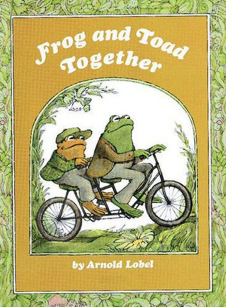 Illustrated book cover for Frog and Toad Together featuring a frog and a toad riding a tandem bicycle. Both are wearing nice clothing. They are biking through a lush, green garden.