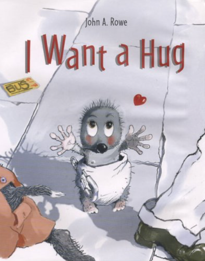 Cover image for the book I Want a Hug with an illustration of a small and very cute fuzzy grey creature in a diaper. The creature looks up imploringly at the viewer and stretches its arms out for a hug. It is standing on a sidewalk littered with a bus ticket. A large leg and foot slant out of the corner, indicating a person walking past