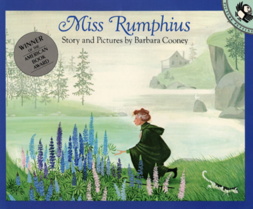 Illustrated book cover for Miss Rumphius featuring a woman kneeling by a patch of blue, purple, and pink lupin flowers. She has light skin and graying red hair and is wearing a black robe. A black and white cat walks next to her. Behind her is a misty lake, pine trees, and a house on a rocky hill.