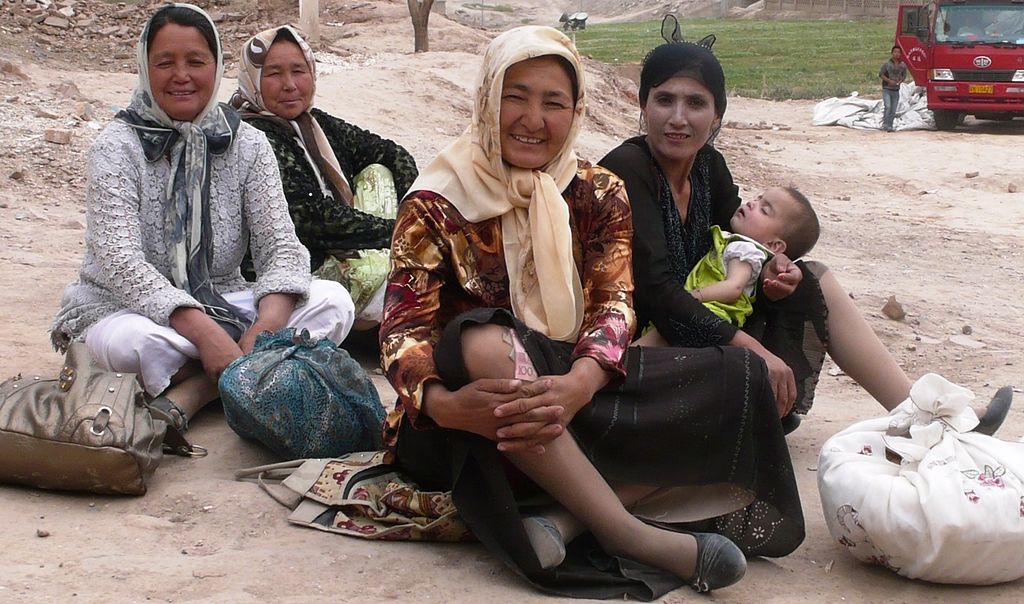 photograph of four Uighur women, one with a baby