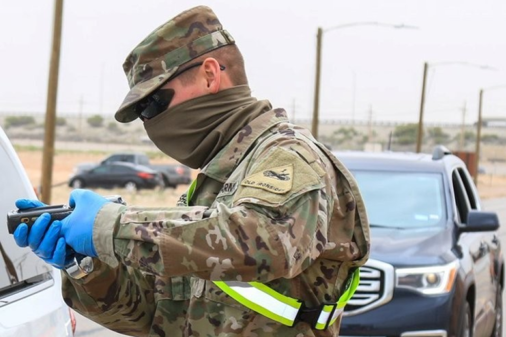 photograph of army reserve personnel wearing neck gaiter at covid testing site