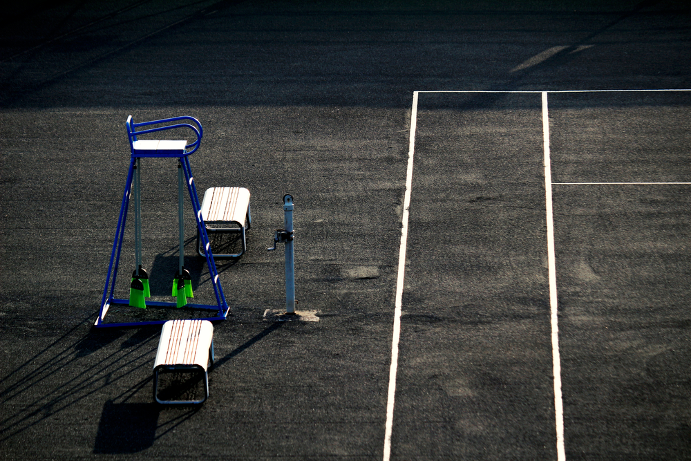 photograph of empty tennis court and judge's chair