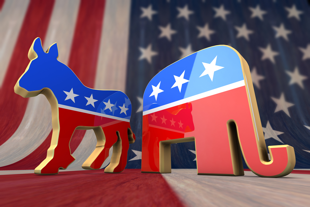 photograph of democratic and republican party figurines atop the American flag