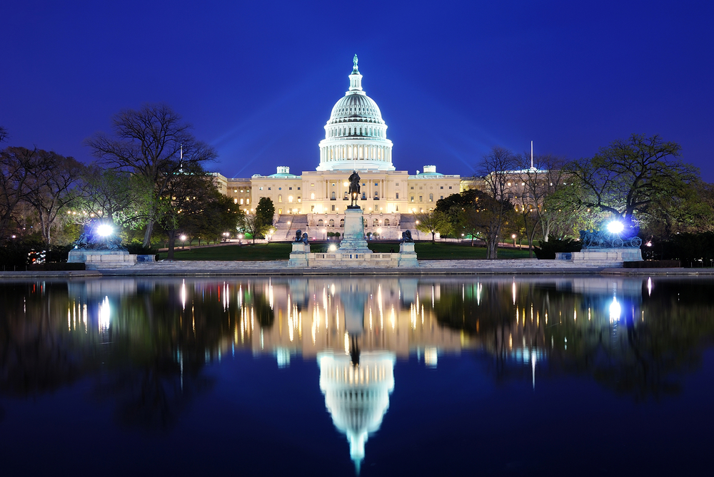 photograph of US Capitol Building with mirror image reflected in lake