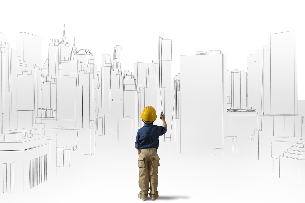 image of child architect with hard hat standing in front of sketch of city skyline