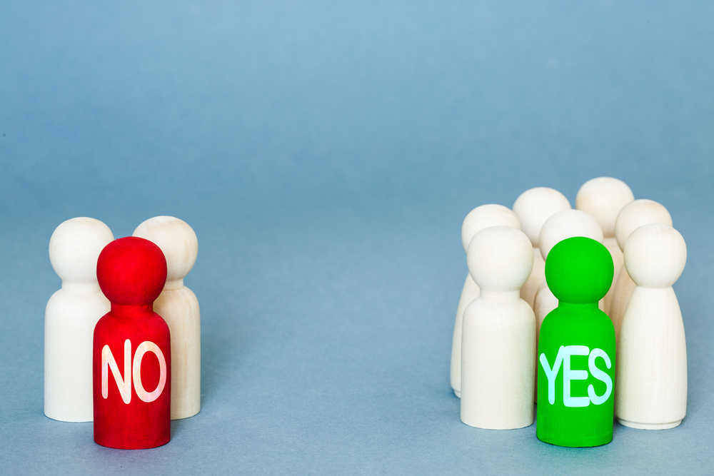 photograph of wooden pins representing peoplewith majority in support and a handful opposed