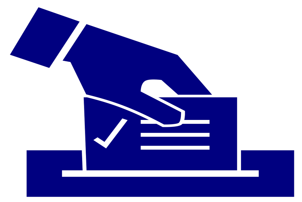 image of hand placing checked ballot in ballot box