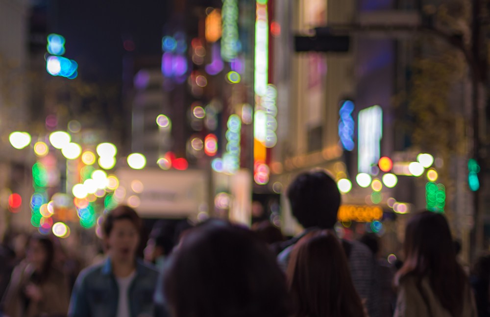 blurred photograph of crowd on busy street at night