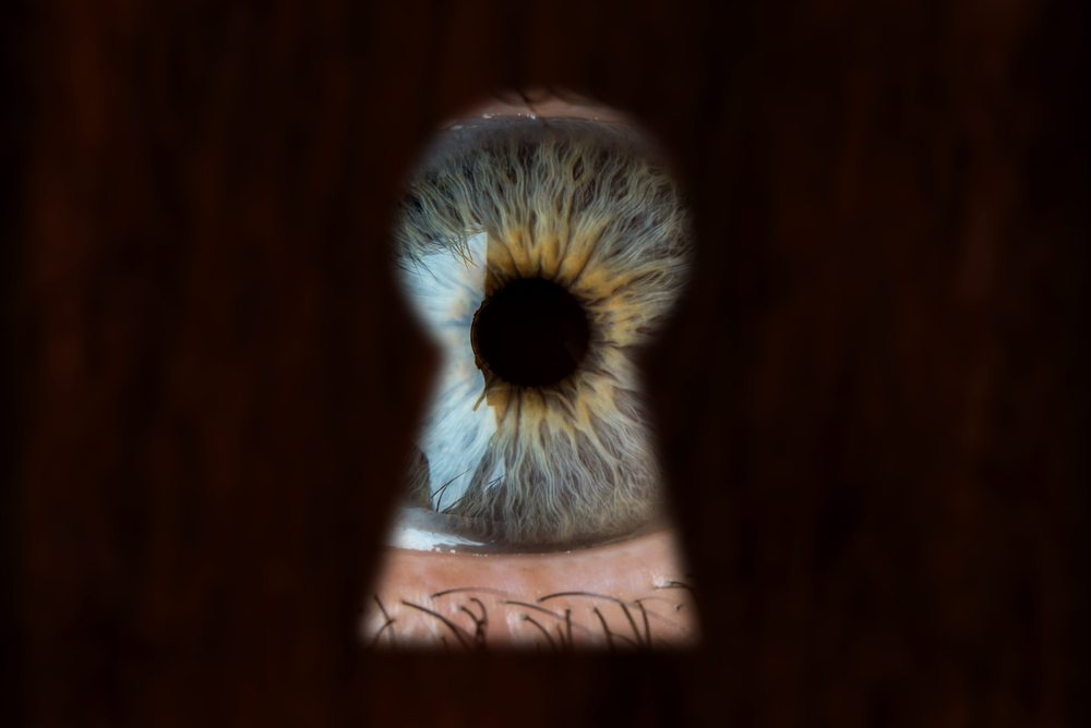 eye looking through keyhole
