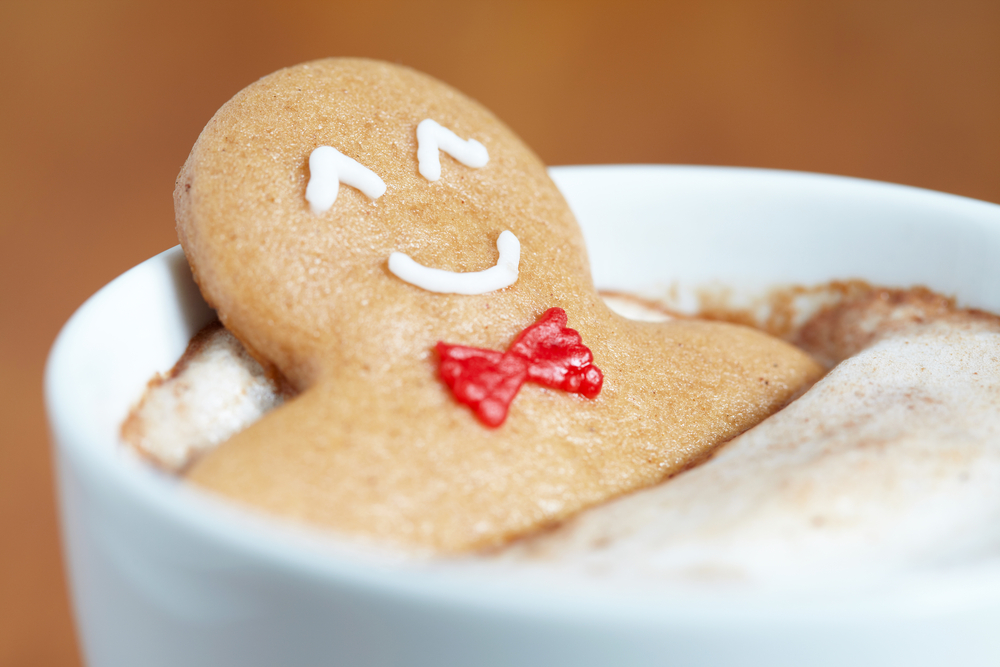 photograph of smiling gingerbread man relaxing in a cup of hot coacoa