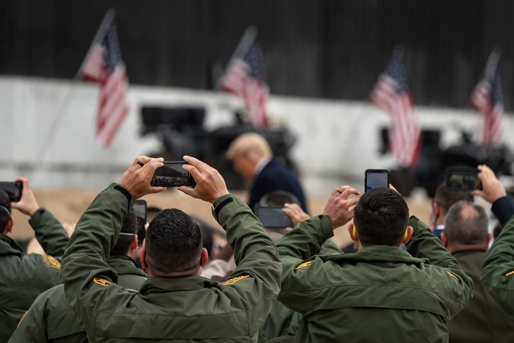 photograph of President Trump leaving podium at border wall event