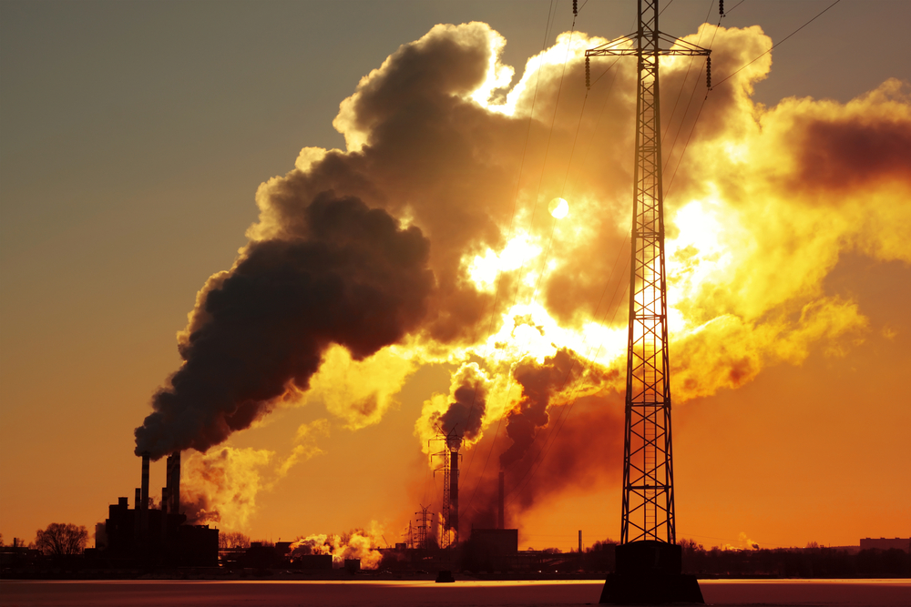 photograph of power plant smoke blotting out sun