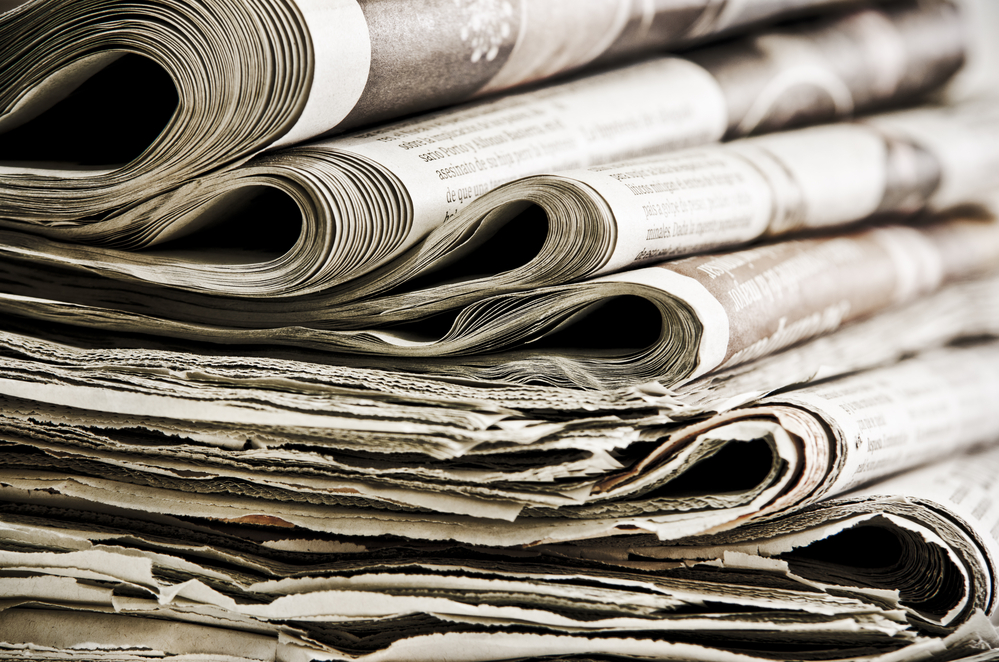 closeup photograph of stack of old newspapers