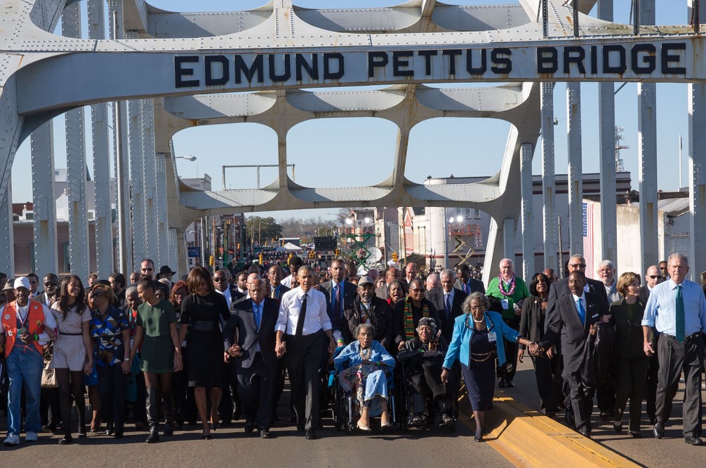 photograph of Selma anniversary march at Edmund Pettus Bridge featuring Barack Obama and John Lewis