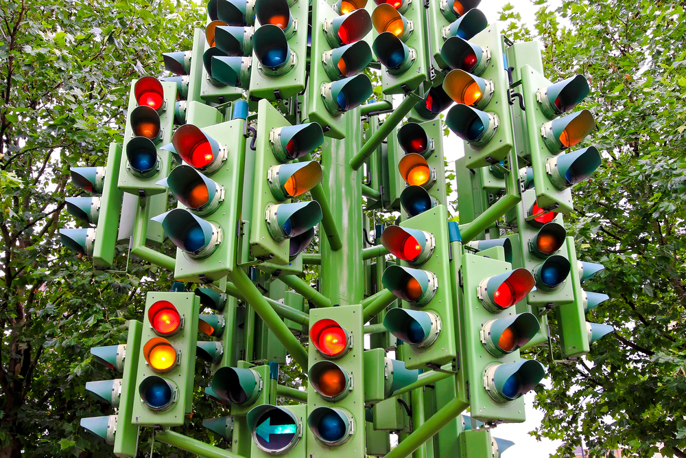 photograph of a cluster of traffic lights sending mixed signals