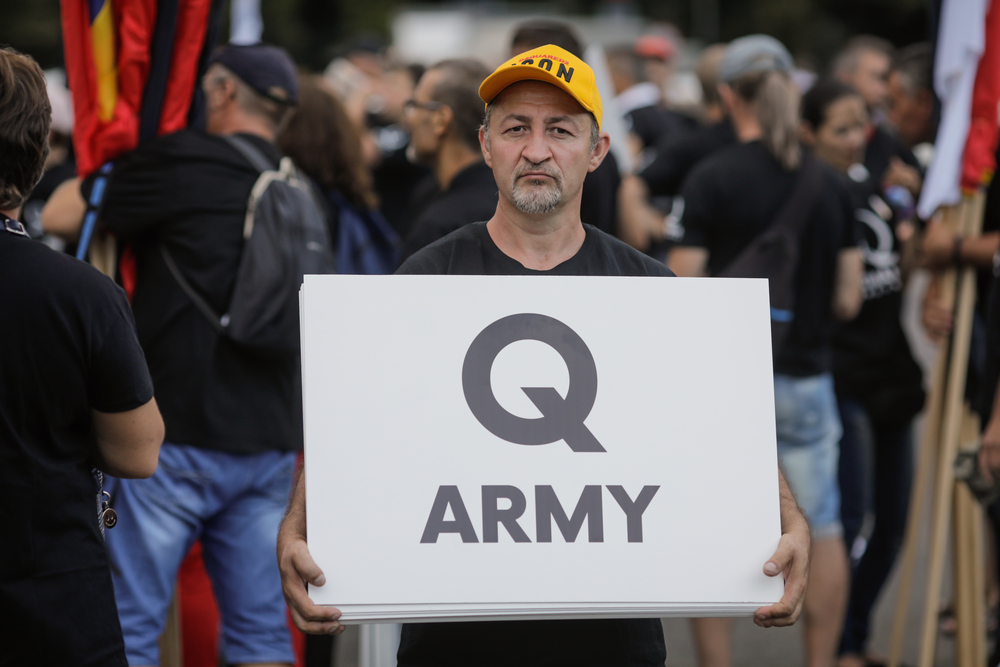 photograph of 'Q Army" sign displayed at political rally