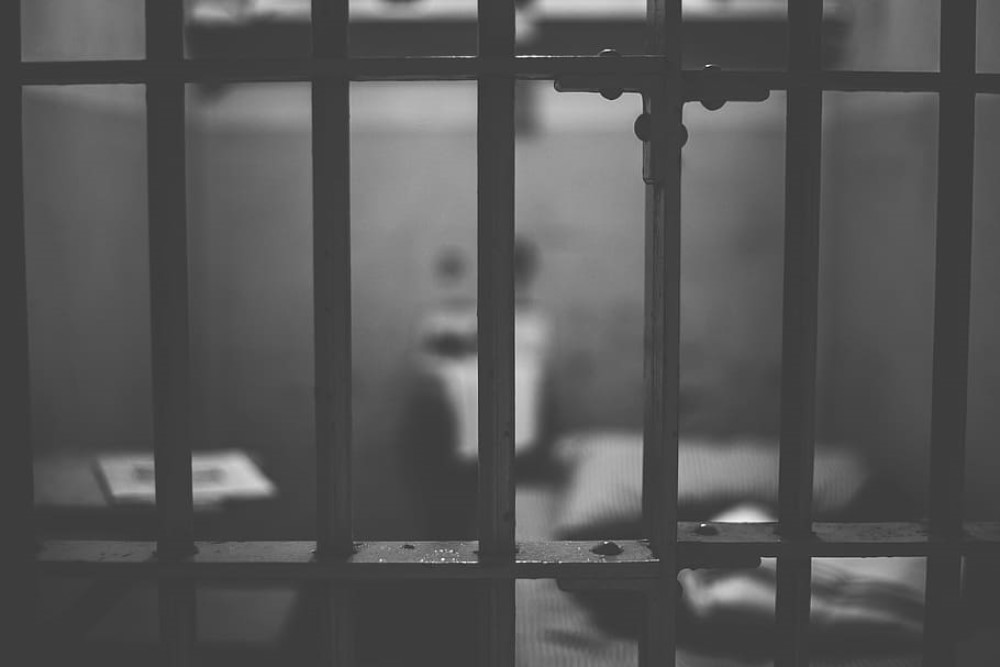 black-and-white photograph of empty jail cell