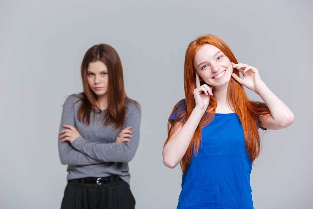 photograph of two young women of different attitudes