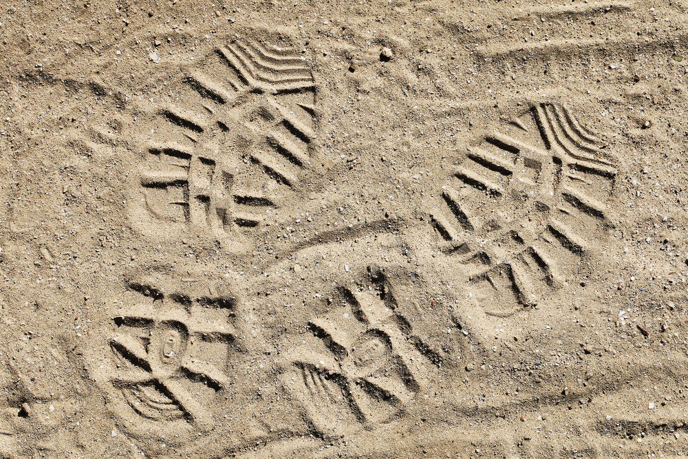 photograph of bootprints in the sand