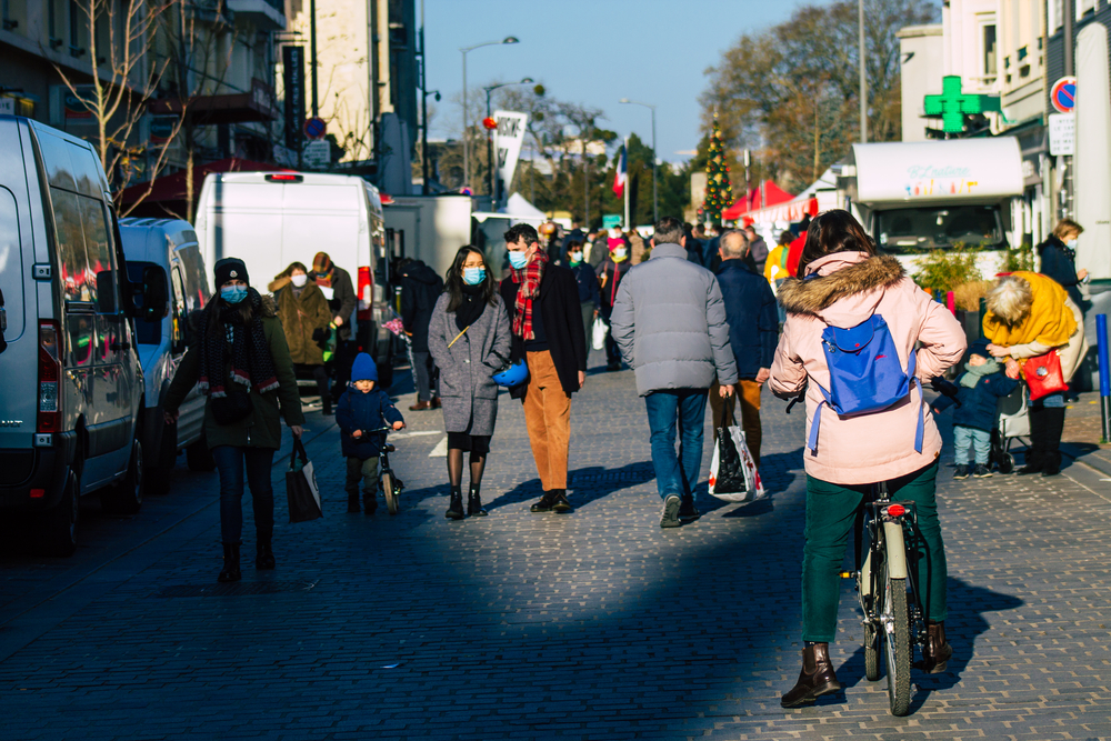 photograph of people walking and biking in masks