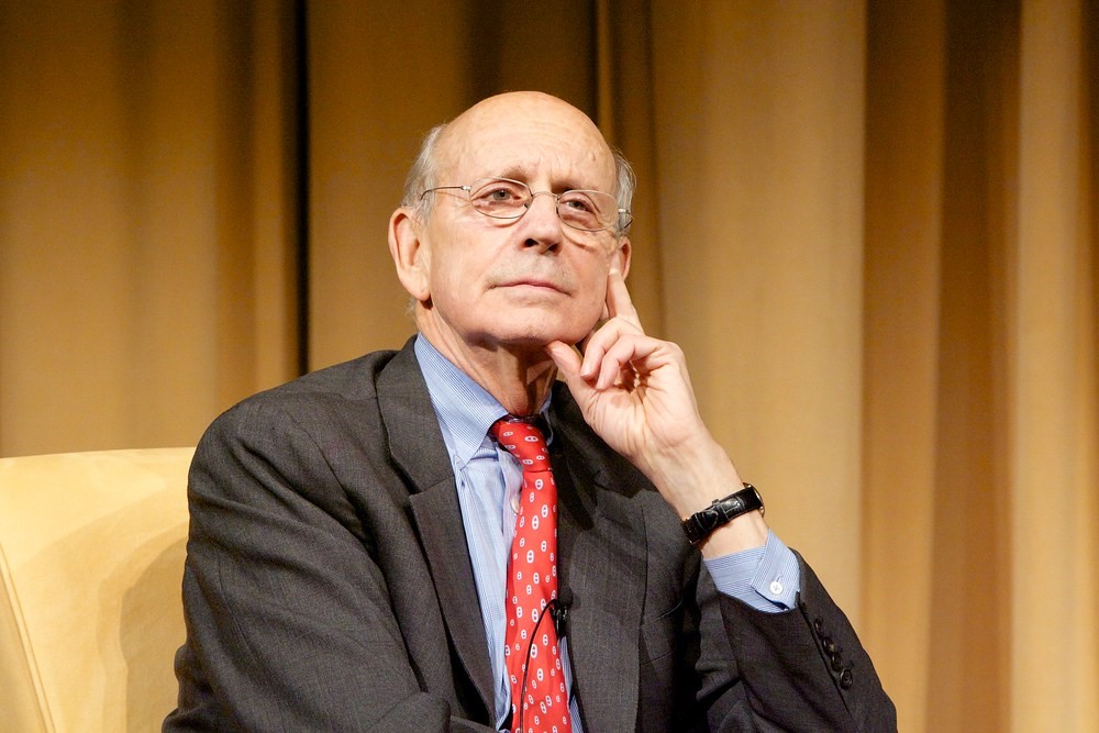 photograph of a contemplative Justice Breyer at a speaking engagement