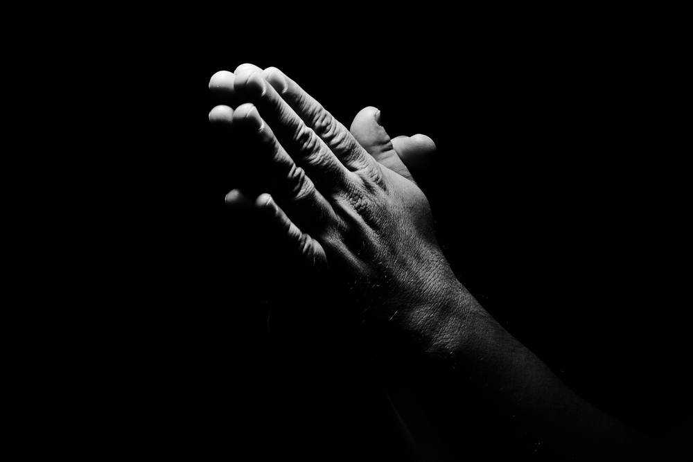 black and white photograph of pray hands