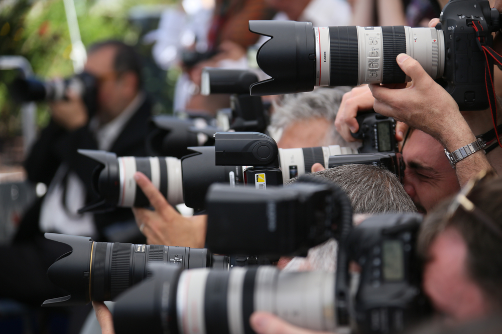 photograph of crowd of paparazzi cameras at event