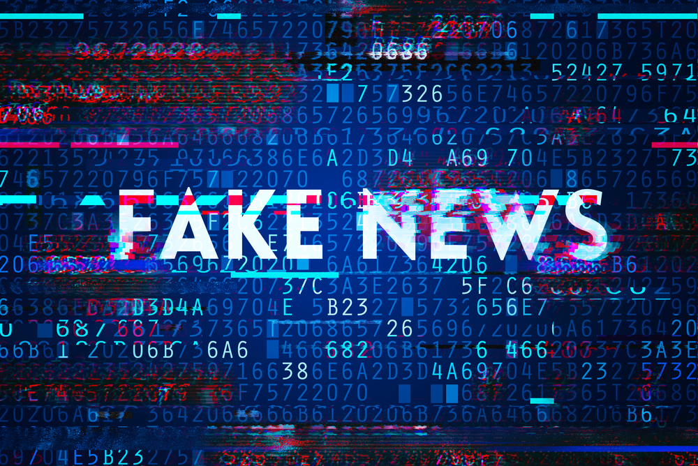 image of glitched "FAKE NEWS" title accompanied by bits of computer code