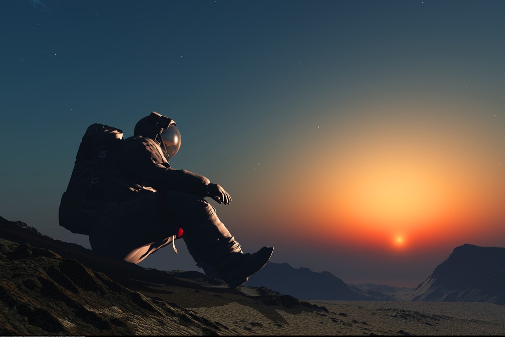 photograph of astronaut sitting on surface of foreign planet at dawn