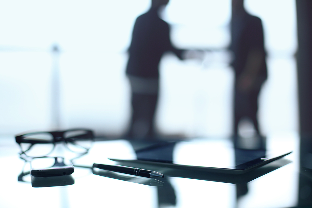 photograph of two silhouettes sitting down for an interview