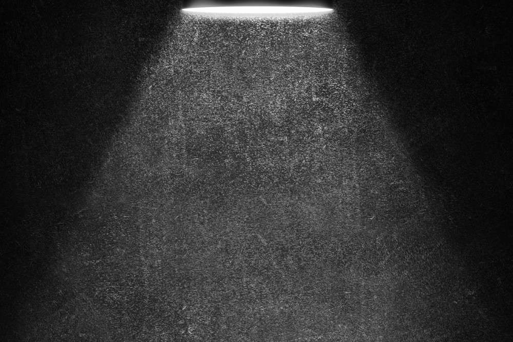 black and white photograph of lamp light in darkness