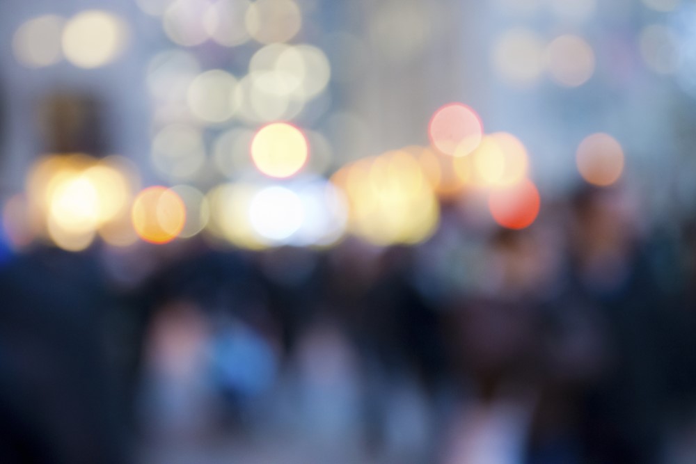 blurred image of crowd and streetlights