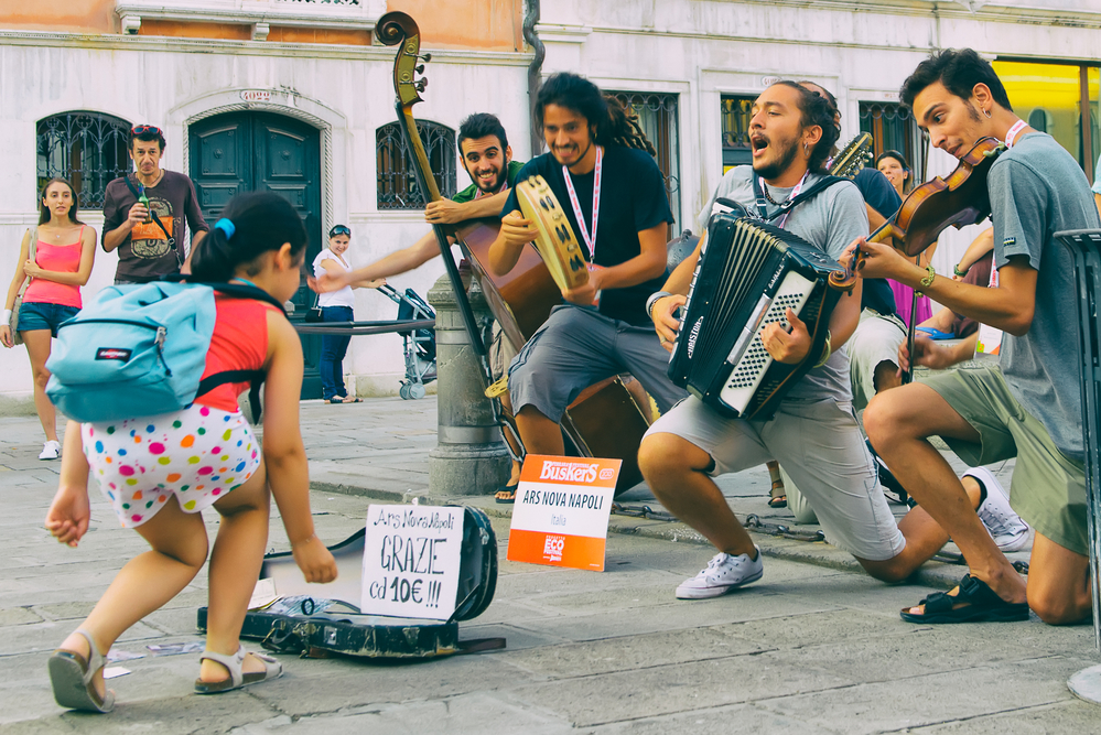 photograph of buskers celebrating child's donation