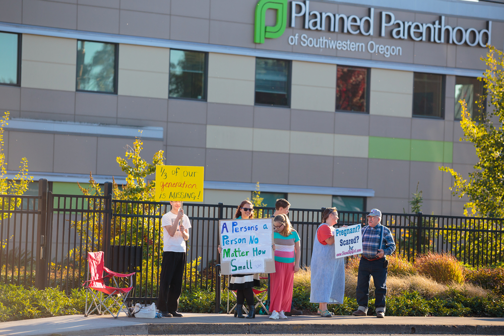 photograph of pro-life protestors in front of Planned Parenthood