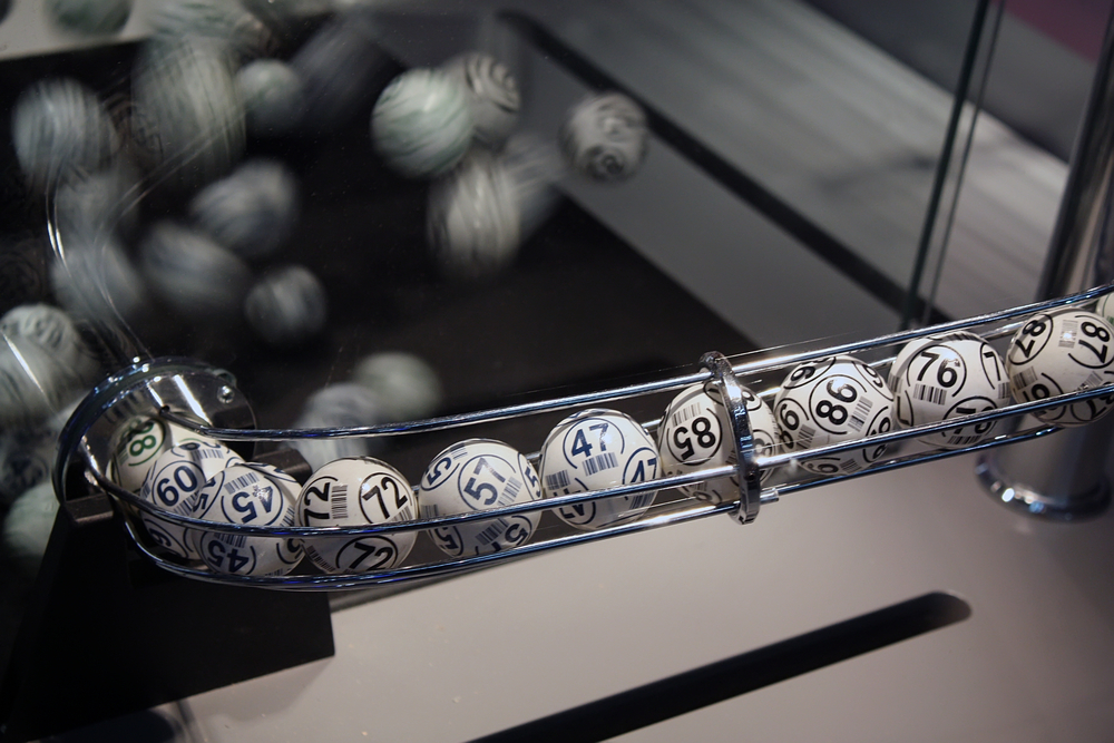 photograph of lottery balls coming out of machine