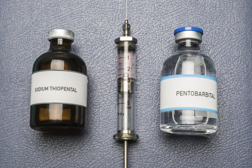 photograph of drug vials and vintage syringe