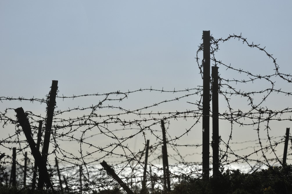 photograph of barbed wire fence at border