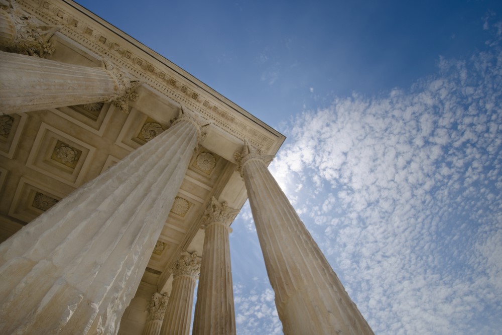 photograph of courthouse columns and sky